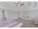 Cozy main bedroom showcasing a tray ceiling and a comfortable seating area at 486 Crestmont Ln, Canton, GA 30114
