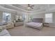Spacious main bedroom featuring a tray ceiling, sitting area, and large windows at 486 Crestmont Ln, Canton, GA 30114