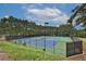 Community tennis courts surrounded by trees and fenced at 486 Crestmont Ln, Canton, GA 30114
