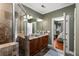 This primary bathroom has a double vanity, shower, and views into the primary bedroom at 700 Piedmont Ne Ave # 4, Atlanta, GA 30308