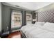 Relaxing bedroom featuring a plush, tufted headboard, neutral tones, and ample natural light at 700 Piedmont Ne Ave # 4, Atlanta, GA 30308