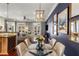 Dining area adjacent to the kitchen and living room with hardwood floors and stylish light fixtures and decor at 700 Piedmont Ne Ave # 4, Atlanta, GA 30308