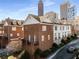 View of brick townhomes with balconies and city backdrop at 700 Piedmont Ne Ave # 4, Atlanta, GA 30308