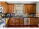 This kitchen features stainless steel appliances, tile backsplash, and wood cabinets and floors at 700 Piedmont Ne Ave # 4, Atlanta, GA 30308