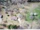 Aerial view of a charming home with a driveway and lush landscaping at 133 Dailey Mill Rd, Mcdonough, GA 30253