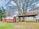 Two backyard storage sheds, one with a window, are featured, with a carport-like structure at 133 Dailey Mill Rd, Mcdonough, GA 30253