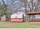 The backyard showcases two storage sheds next to a carport-style structure at 133 Dailey Mill Rd, Mcdonough, GA 30253