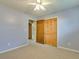 Bedroom featuring louvered closet doors and neutral carpeting at 133 Dailey Mill Rd, Mcdonough, GA 30253