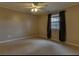 A cozy bedroom featuring neutral walls, a ceiling fan, and a window with dark curtains at 133 Dailey Mill Rd, Mcdonough, GA 30253