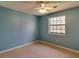 A bright blue bedroom with a window and neutral carpeting at 133 Dailey Mill Rd, Mcdonough, GA 30253
