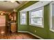 An interior shot of a bright green bay window breakfast nook with wood floors and view to the yard at 133 Dailey Mill Rd, Mcdonough, GA 30253