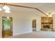 Inviting living room features a stone fireplace, exposed beam, and seamless flow to the adjacent rooms at 133 Dailey Mill Rd, Mcdonough, GA 30253