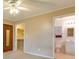 Spacious main bedroom featuring a ceiling fan, en suite bathroom, and walk-in closet at 133 Dailey Mill Rd, Mcdonough, GA 30253