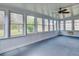 A bright sun room features a ceiling fan and lots of windows with views to the outside at 133 Dailey Mill Rd, Mcdonough, GA 30253