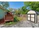 This backyard has a deck, storage shed, rock features, and full perimeter fencing at 1518 Langston Sw Ave, Atlanta, GA 30310