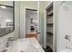 This bathroom features a marble countertop, a decorative shelving area, and modern fixtures at 1518 Langston Sw Ave, Atlanta, GA 30310