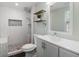 Modern bathroom featuring tiled shower, stone floor, and stylish fixtures with plenty of light at 1518 Langston Sw Ave, Atlanta, GA 30310