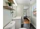 This bathroom features black tile flooring, a modern sink, and a decorative shelf at 1518 Langston Sw Ave, Atlanta, GA 30310