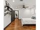 The bedroom boasts beautiful hardwood floors, decorative shelves, and a spacious layout at 1518 Langston Sw Ave, Atlanta, GA 30310
