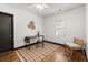 Bright bedroom featuring hardwood floors, a ceiling fan, and a desk with a chair at 1518 Langston Sw Ave, Atlanta, GA 30310