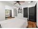 The bedroom boasts hardwood floors, black trim, shelving, and a ceiling fan at 1518 Langston Sw Ave, Atlanta, GA 30310