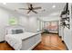 Bright bedroom featuring white wood floors, white walls, large windows, and a ceiling fan at 1518 Langston Sw Ave, Atlanta, GA 30310