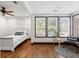 Bright bedroom with a sitting room area, a ceiling fan, and natural light from multiple windows at 1518 Langston Sw Ave, Atlanta, GA 30310