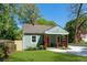 Charming renovated bungalow with a cozy front porch, freshly painted exterior, and lush green lawn at 1518 Langston Sw Ave, Atlanta, GA 30310