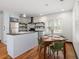 Well-lit kitchen with stainless steel appliances, custom cabinets and adjacent dining area at 1518 Langston Sw Ave, Atlanta, GA 30310