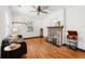 Cozy living room with hardwood floors, a stylish sofa, and a charming brick fireplace at 1518 Langston Sw Ave, Atlanta, GA 30310