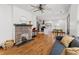 Open living space featuring hardwood floors, brick fireplace, and access to the kitchen at 1518 Langston Sw Ave, Atlanta, GA 30310