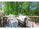 Beautiful deck with outdoor furniture, grill, and a view of the lush greenery at 160 Brookhollow Trce, Alpharetta, GA 30022