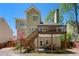 Rear exterior of a home with a two-level deck with stairs to the back yard at 160 Brookhollow Trce, Alpharetta, GA 30022