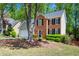 Charming two-story brick home with a well-manicured front yard, classic windows, and an attached garage at 160 Brookhollow Trce, Alpharetta, GA 30022