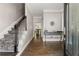 Inviting foyer with hardwood floors, decorative mirror, and staircase with runner at 160 Brookhollow Trce, Alpharetta, GA 30022