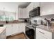 Beautiful kitchen featuring granite countertops, stainless steel appliances, and modern finishes at 160 Brookhollow Trce, Alpharetta, GA 30022