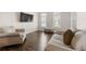 Cozy living room featuring two large sofas, natural light, and hardwood floors at 160 Brookhollow Trce, Alpharetta, GA 30022