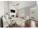 Bright and airy living room with fireplace, vaulted ceiling, and large windows at 160 Brookhollow Trce, Alpharetta, GA 30022