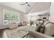 Open concept living room leading to the kitchen, featuring hardwood floors and neutral decor at 160 Brookhollow Trce, Alpharetta, GA 30022