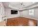 Large living room with hardwood floors, a ceiling fan, and natural light from a large window at 160 Brookhollow Trce, Alpharetta, GA 30022