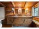 Bathroom with wood walls, custom vanity with double sinks, and decorative lighting at 3401 Clay Rd, Austell, GA 30106