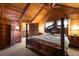 Vaulted wood ceiling, four-poster bed and cozy decor give this bedroom a rustic feel at 3401 Clay Rd, Austell, GA 30106