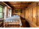 Bedroom showcasing wood walls, natural lighting, and rustic decor elements at 3401 Clay Rd, Austell, GA 30106