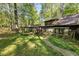 Log cabin with a stone walkway and views of the surrounding trees at 3401 Clay Rd, Austell, GA 30106