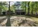Log cabin with a covered area and an additional cabin surrounded by lush greenery and mature trees at 3401 Clay Rd, Austell, GA 30106