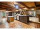 Open log cabin kitchen, featuring brick floors, and wooden cabinets at 3401 Clay Rd, Austell, GA 30106