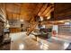 Open-concept log cabin living space with fireplace, loft, and kitchen view at 3401 Clay Rd, Austell, GA 30106
