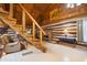 Log cabin interior with stone fireplace, staircase, and wood accents at 3401 Clay Rd, Austell, GA 30106