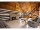 Spacious log cabin living room with stone fireplace, wooden ceiling, and stairs at 3401 Clay Rd, Austell, GA 30106