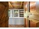 Room with rustic door and brick flooring with large freezer for storage at 3401 Clay Rd, Austell, GA 30106